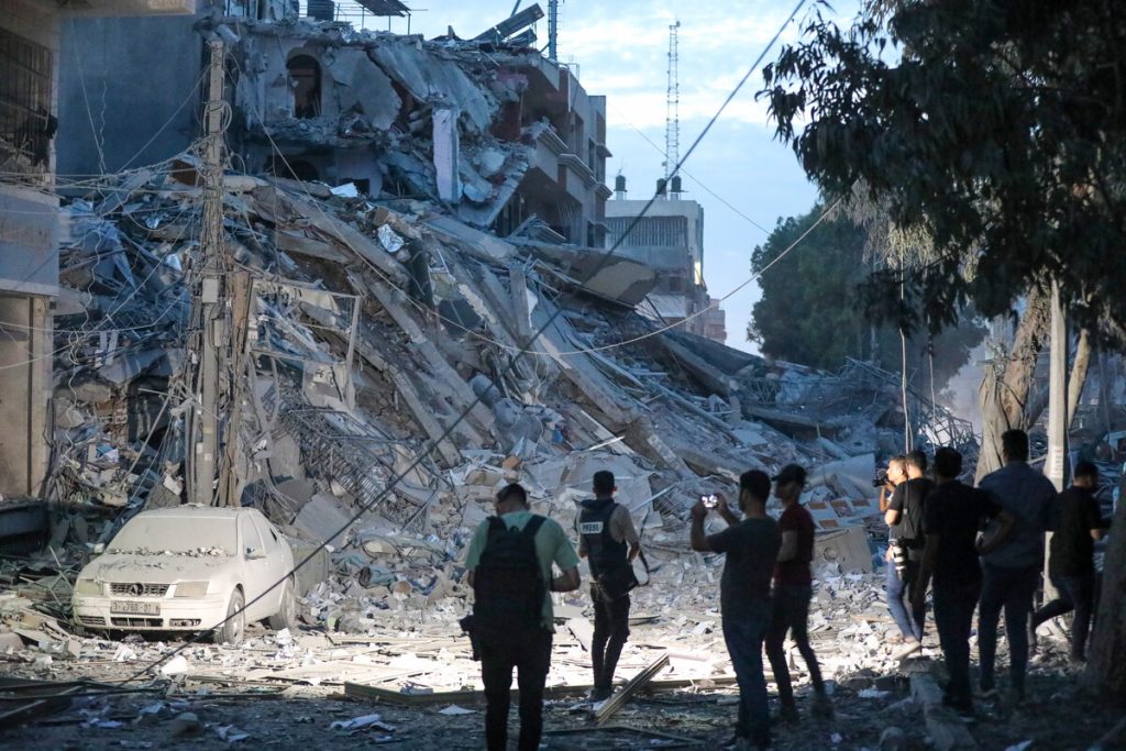 Residents inspect the damage to Gaza City following bombing by the Israeli army.